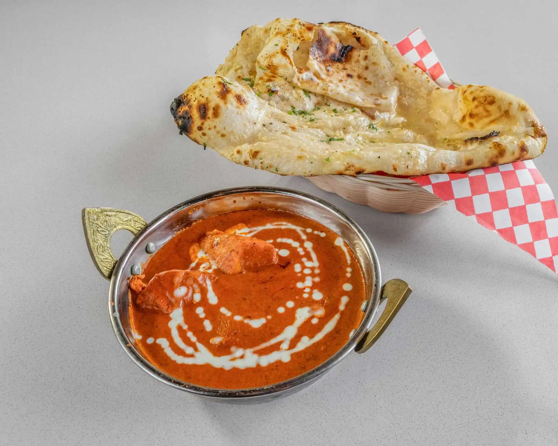 Butter chicken curry with garlic naan at Rockfort Authentic Chettinadu & Indian Cuisine, Calgary