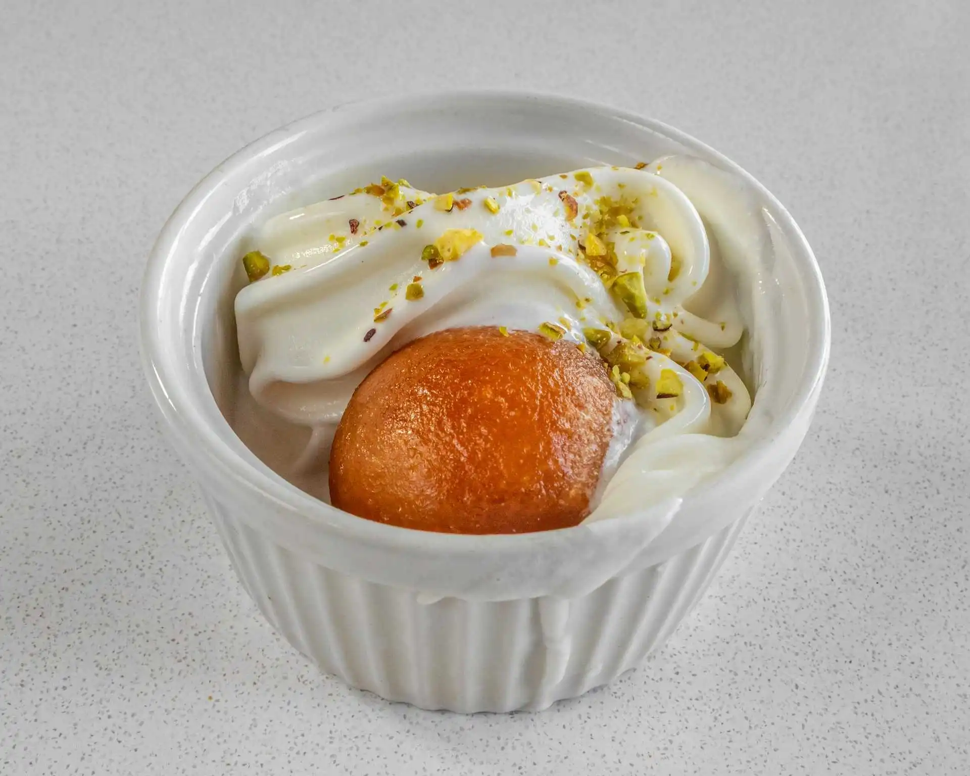 Gulab jamun dessert with ice cream and pistachios at Rockfort Authentic Chettinadu & Indian Cuisine, Calgary